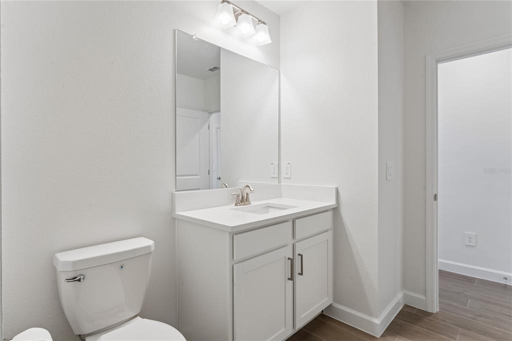 6692 Homebound Way New Port Richey, FL 34653 - Photo 33 of 47 a bathroom with a toilet a sink and mirror