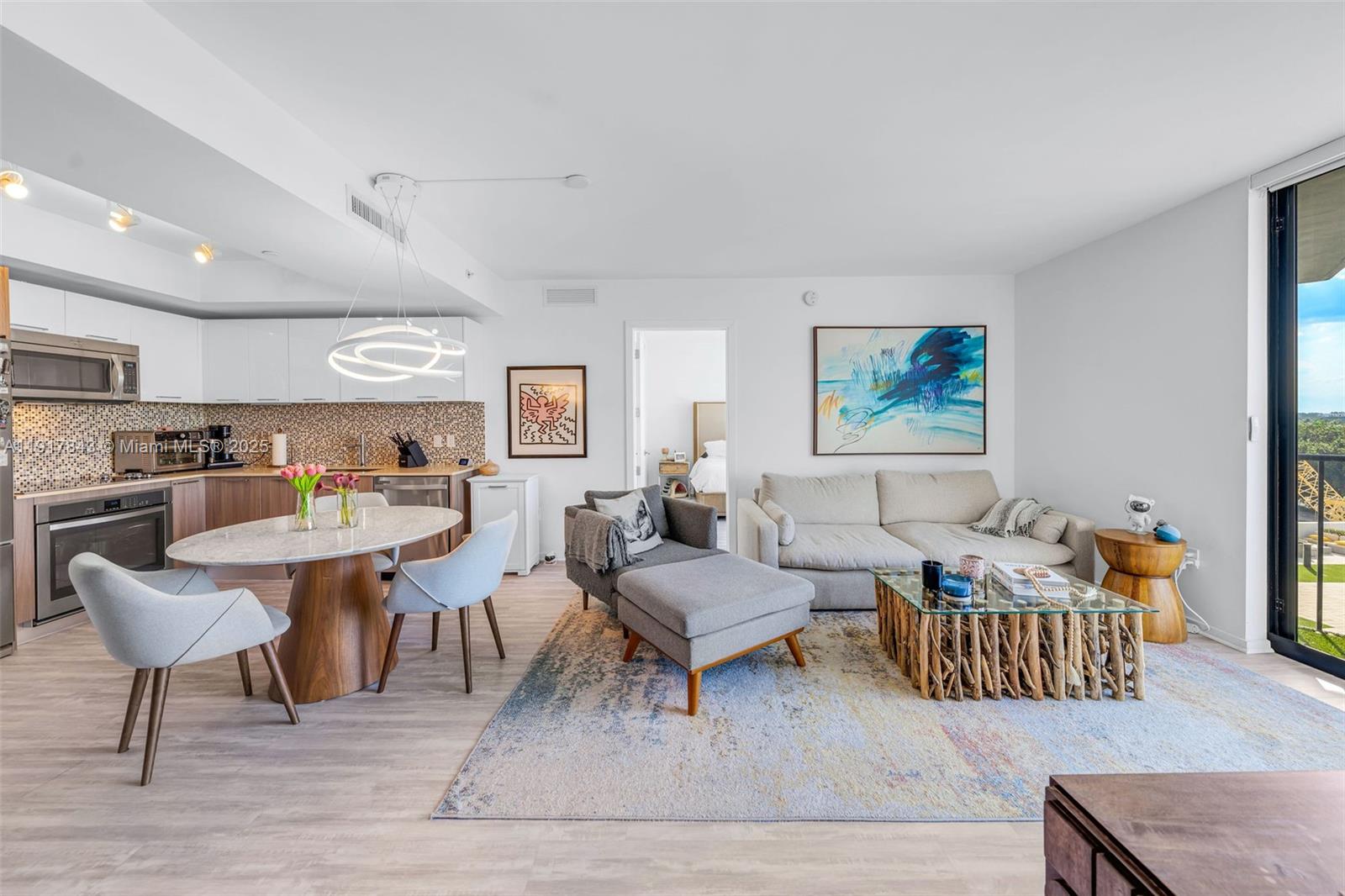 5252 Northwest 85th Avenue, Unit 504 Doral, FL 33166 - Photo 11 of 31 a living room with furniture kitchen view and a wooden floor