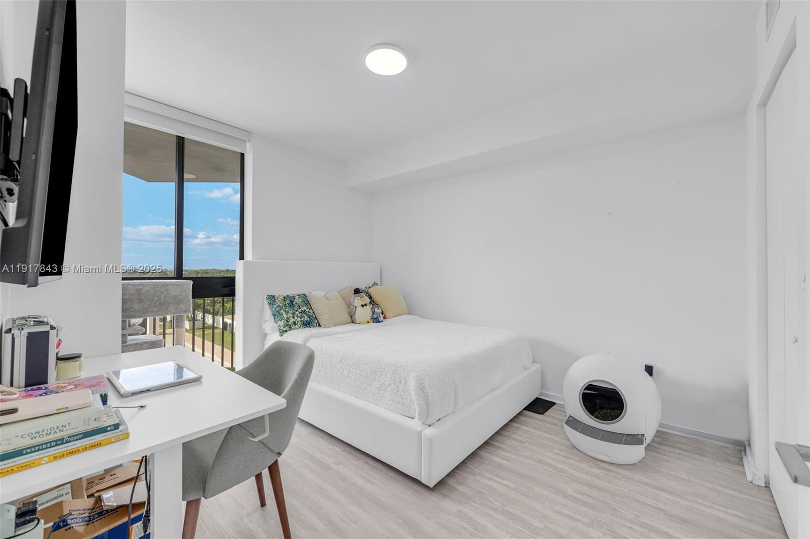 5252 Northwest 85th Avenue, Unit 504 Doral, FL 33166 - Photo 14 of 31 a bedroom with a bed a desk and chair