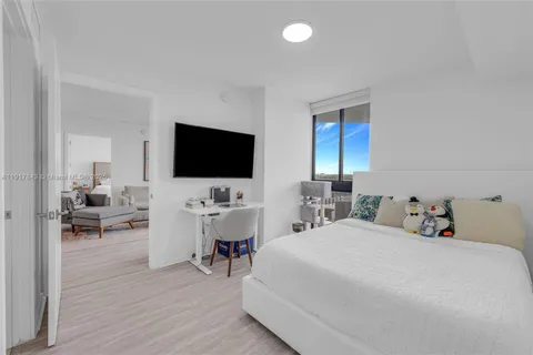 a view of a livingroom with furniture and a flat screen tv