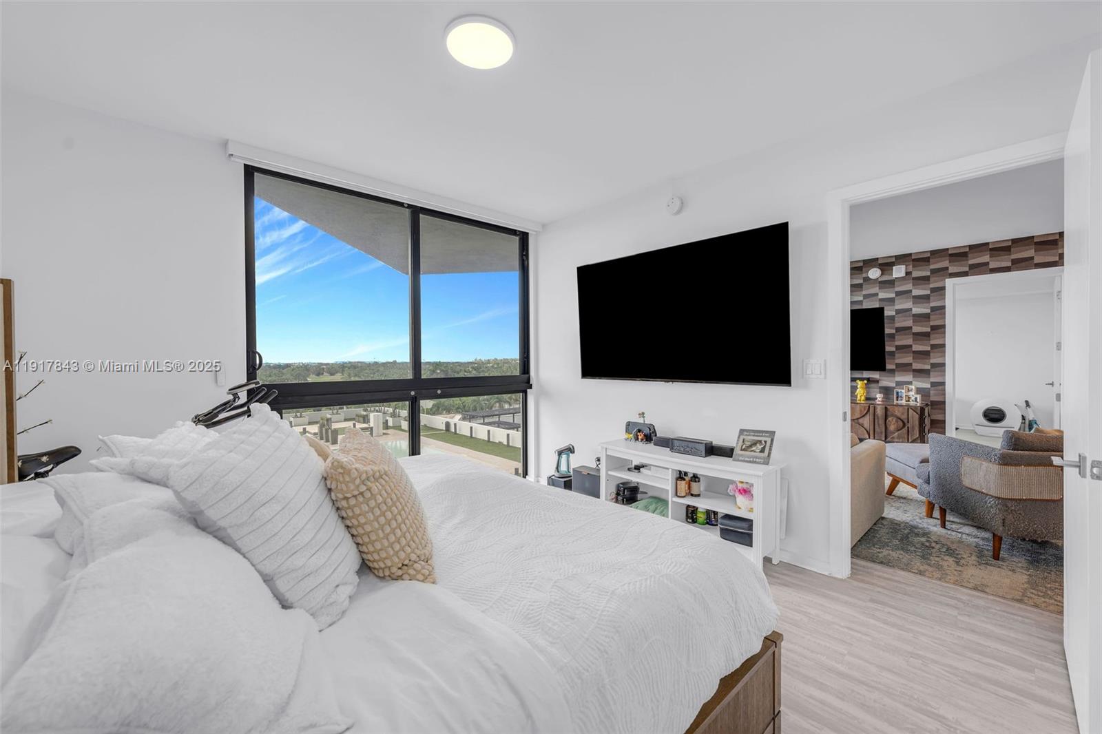 5252 Northwest 85th Avenue, Unit 504 Doral, FL 33166 - Photo 20 of 31 a bedroom with a bed and a flat screen tv