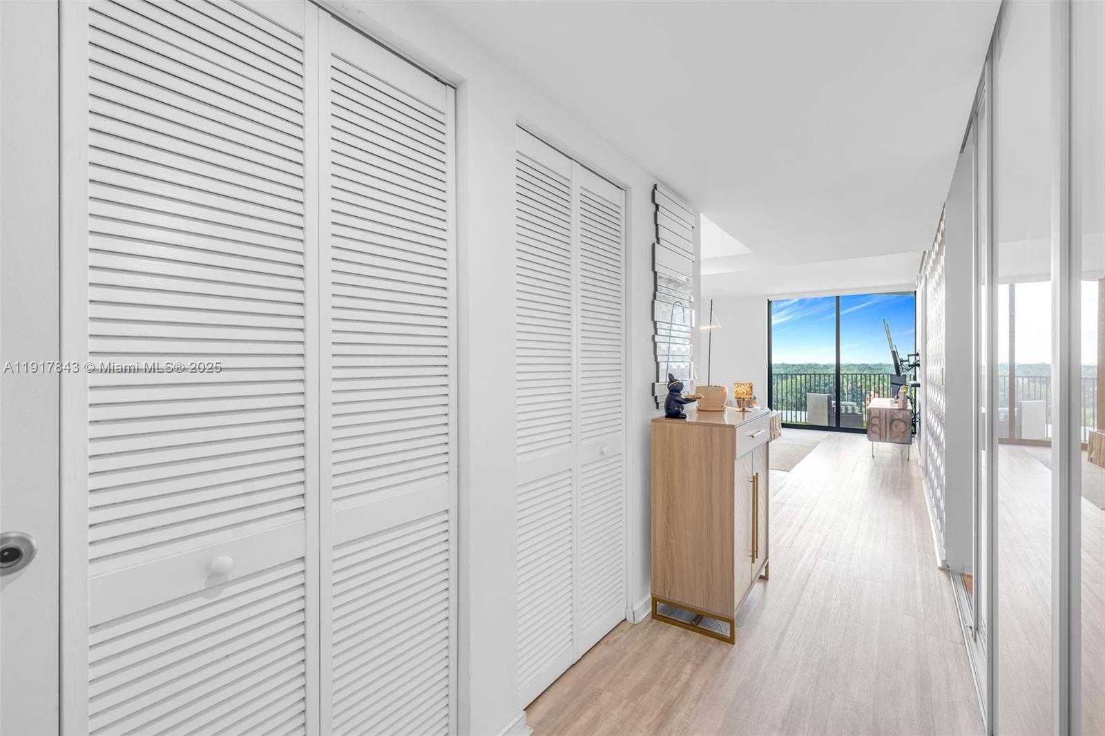 5252 Northwest 85th Avenue, Unit 504 Doral, FL 33166 - Photo 24 of 31 a view of a hallway with wooden floor and a bathroom