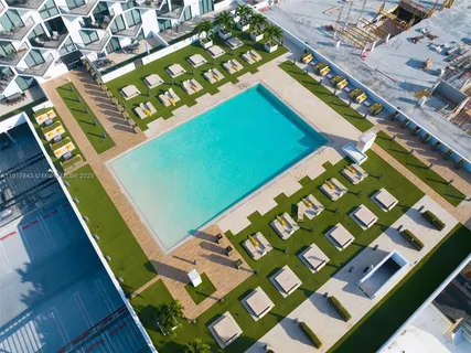 a view of a tennis ground with a large screen