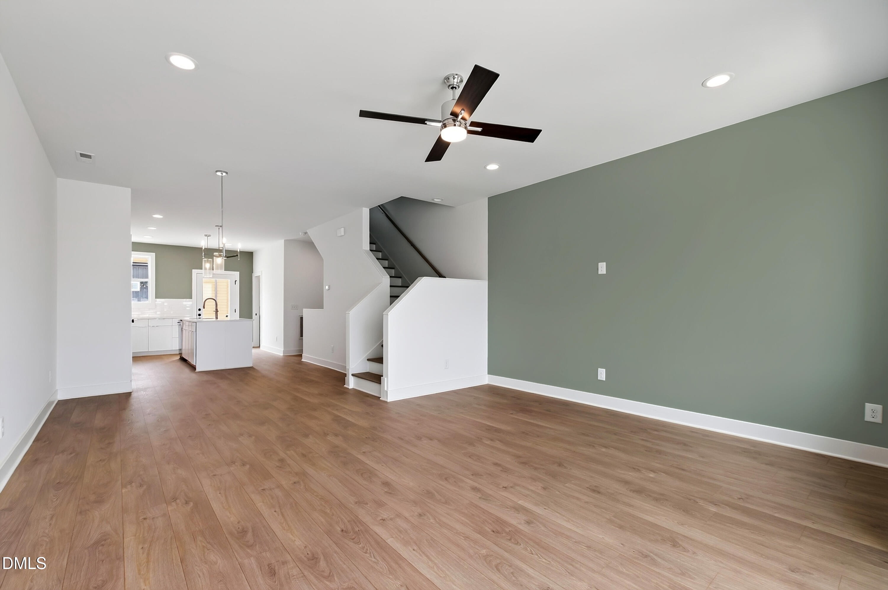 1317 Garner Road, Unit 102 Raleigh, NC 27610 - Photo 24 of 44 a view of a livingroom with a ceiling fan and wooden floor