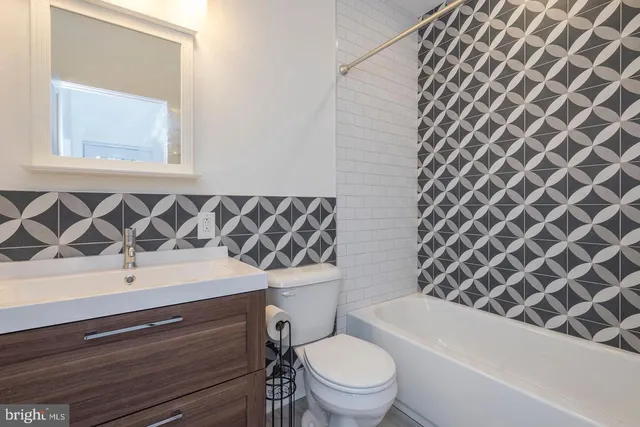 a bathroom with a toilet a sink and a bathtub