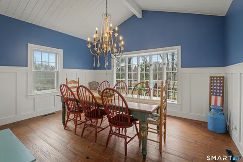 a view of a dining room with furniture wooden floor and chandelier
