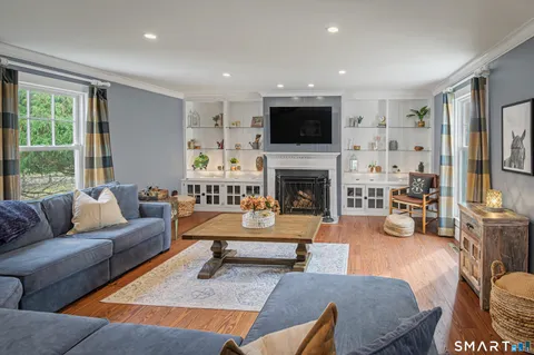 a living room with furniture fireplace and a flat screen tv