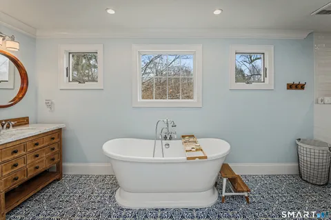 a white bath tub sitting next to a bathroom