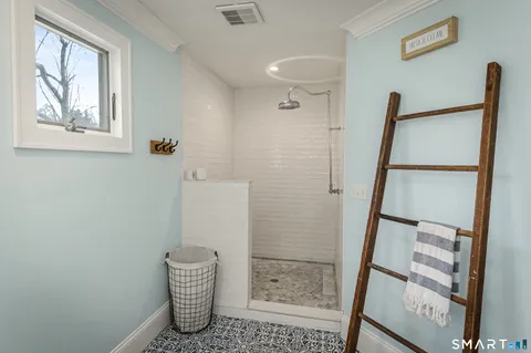 a bathroom with a shower and a window