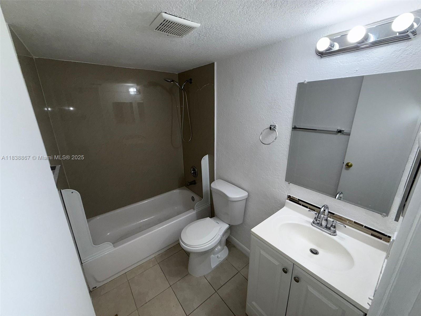 8560 Sherman Circle North, Unit 105 Miramar, FL 33025 - Photo 13 of 14 a bathroom with a sink a toilet and shower