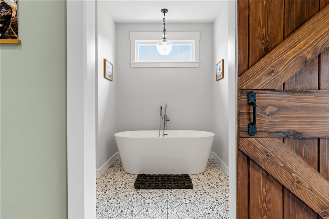 1158 Pyle Road Clarksville, OH 45113 - Photo 30 of 76 This private bath features a soaking tub and elegant patterned tile flooring.