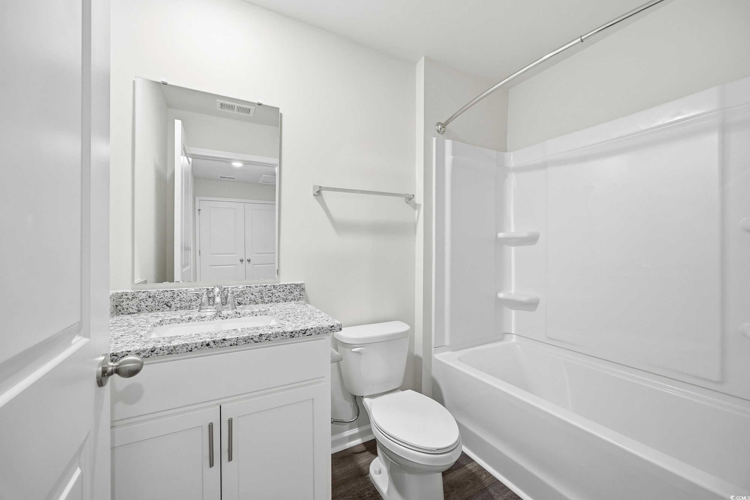322 Honeystone Street Conway, SC 29526 - Photo 20 of 30 Bathroom with shower combination, vanity, and dark wood-style flooring