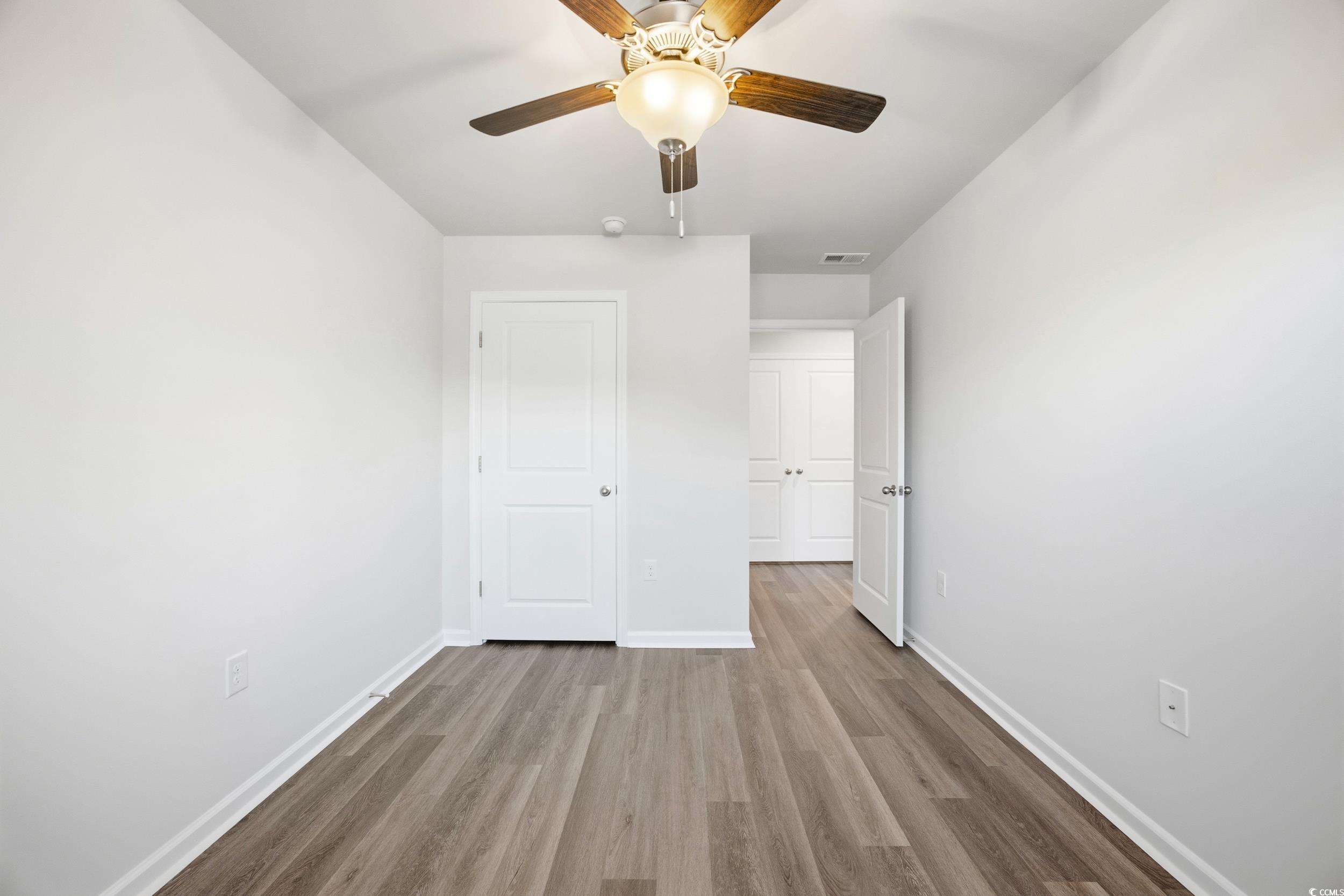 322 Honeystone Street Conway, SC 29526 - Photo 21 of 30 Unfurnished bedroom with wood finished floors and a ceiling fan