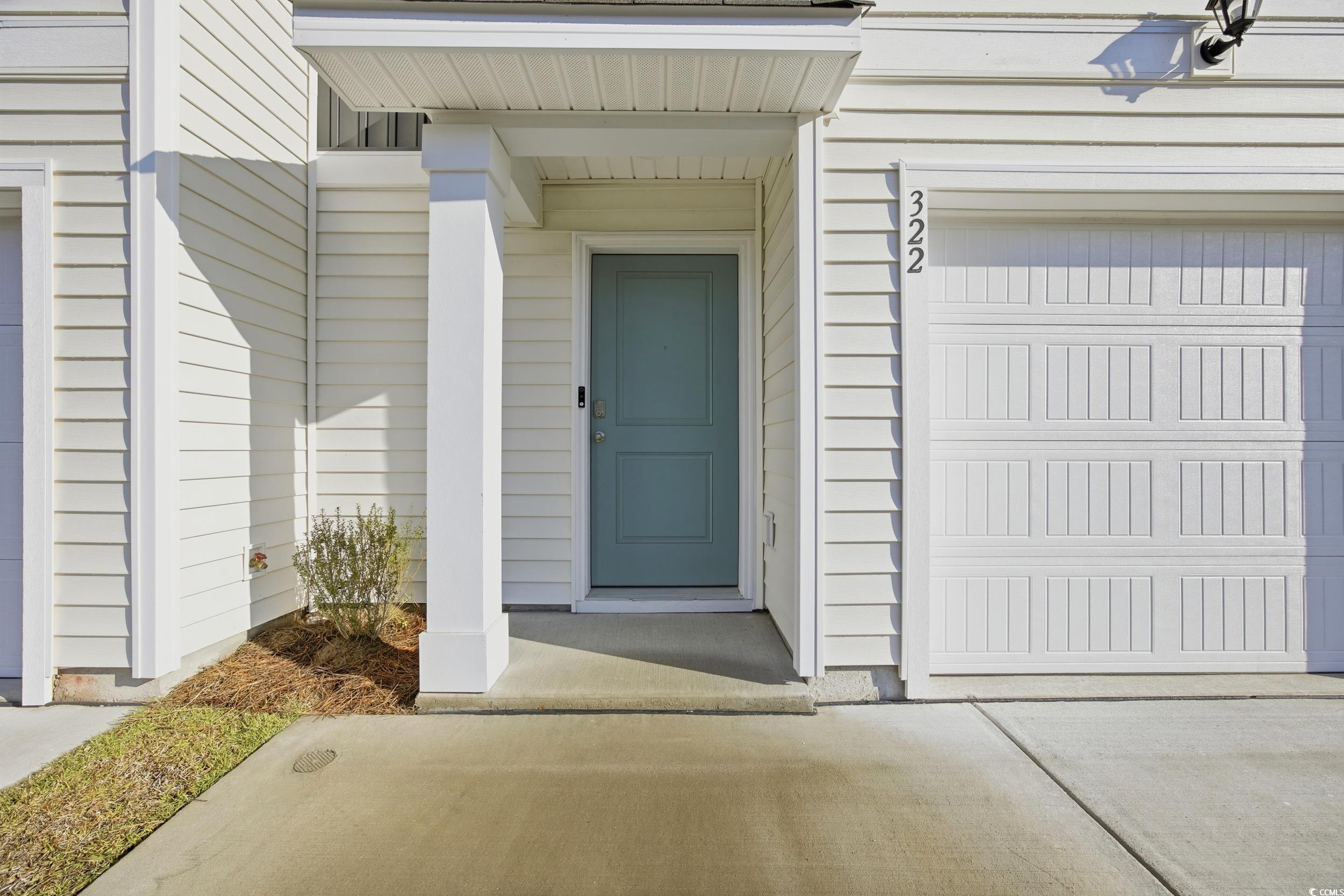 322 Honeystone Street Conway, SC 29526 - Photo 26 of 30 View of exterior entry with a garage