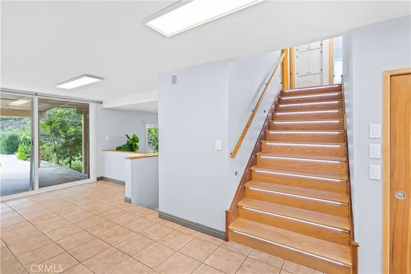 a view of entryway with wooden floor and front door