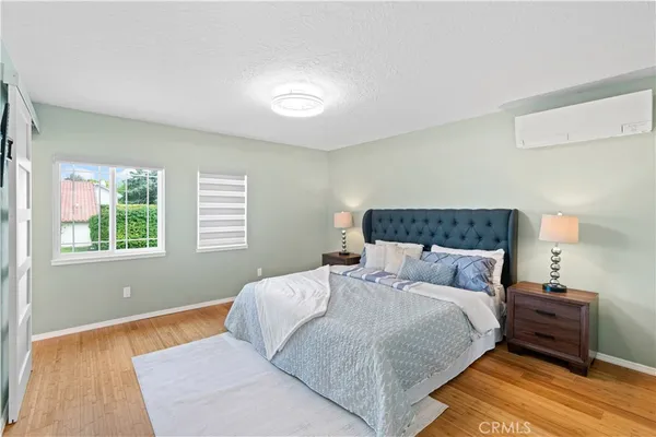 a bedroom with a bed and a night stand