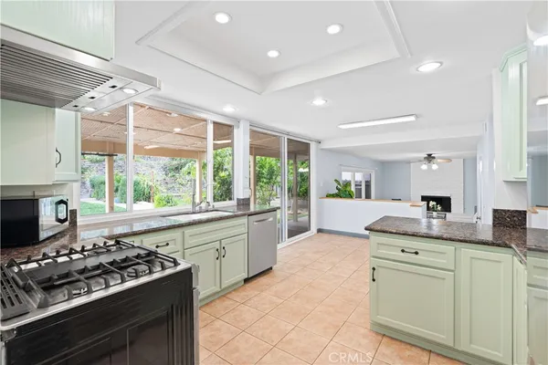 a kitchen with kitchen island a stove a sink and a refrigerator