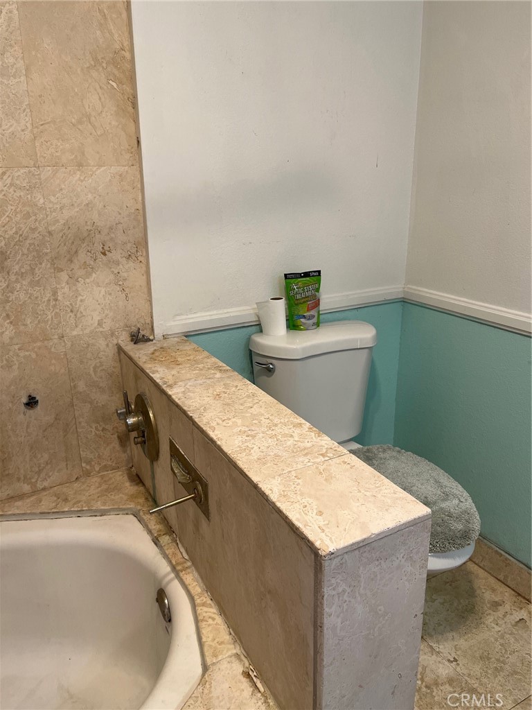 34667 Borchard Road, Unit R Lake Elsinore, CA 92530 - Photo 15 of 20 a bath tub sitting in a bathroom next to a sink