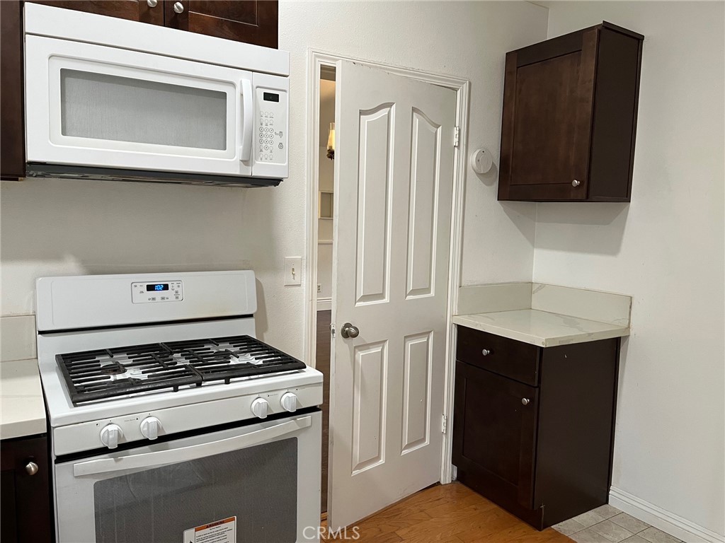 34667 Borchard Road, Unit R Lake Elsinore, CA 92530 - Photo 3 of 20 a kitchen with a stove and a microwave