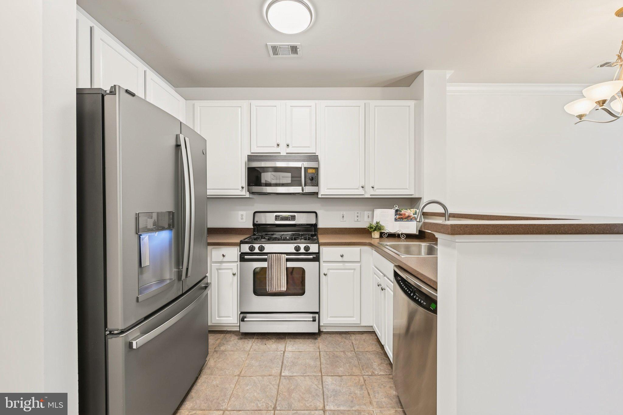 12001 Market Street, Unit 145 Reston, VA 20190 - Photo 4 of 46 Kitchen with Corian countertops