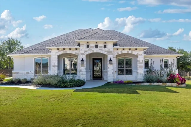 a front view of a house with garden