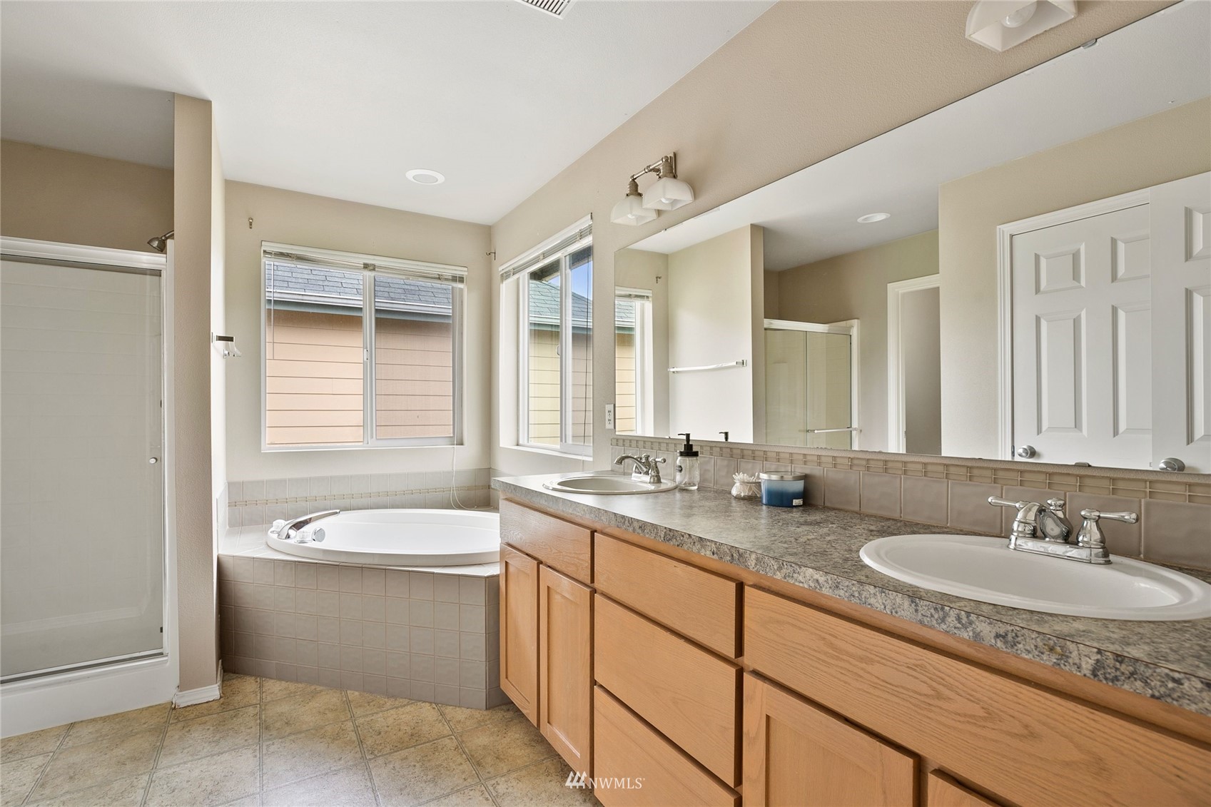 6924 Inlay Street Southeast Lacey, WA 98513 - Photo 12 of 20 a bathroom with a granite countertop sink and a bathtub