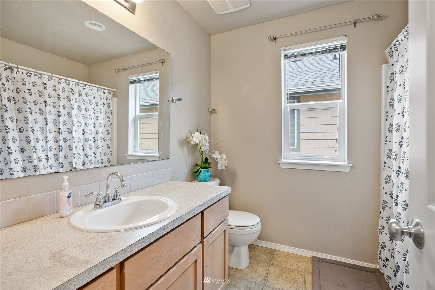 6924 Inlay Street Southeast Lacey, WA 98513 - Photo 16 of 20 a bathroom with a sink toilet and a mirror