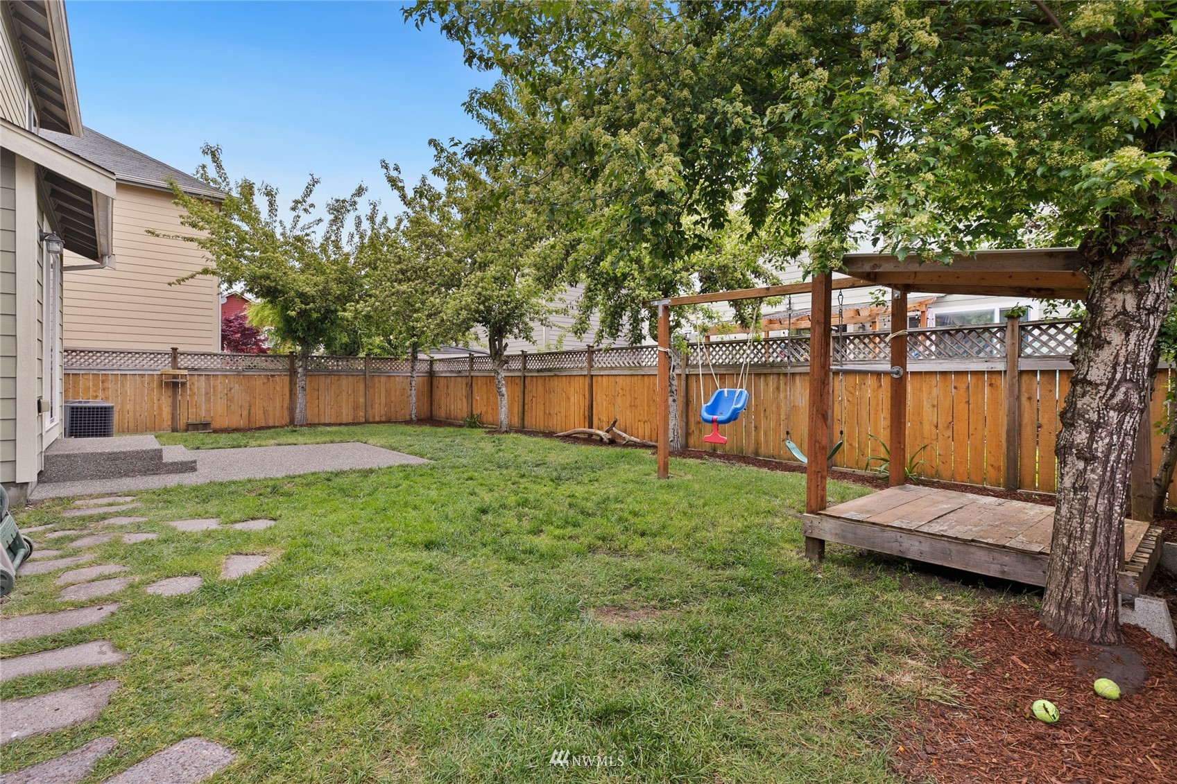 6924 Inlay Street Southeast Lacey, WA 98513 - Photo 19 of 20 a view of a backyard with a large tree and a park