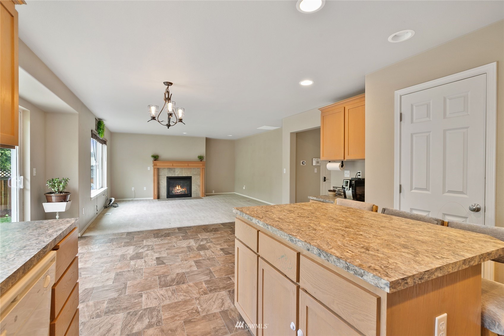 6924 Inlay Street Southeast Lacey, WA 98513 - Photo 4 of 20 a bedroom with a large bed and a chandelier