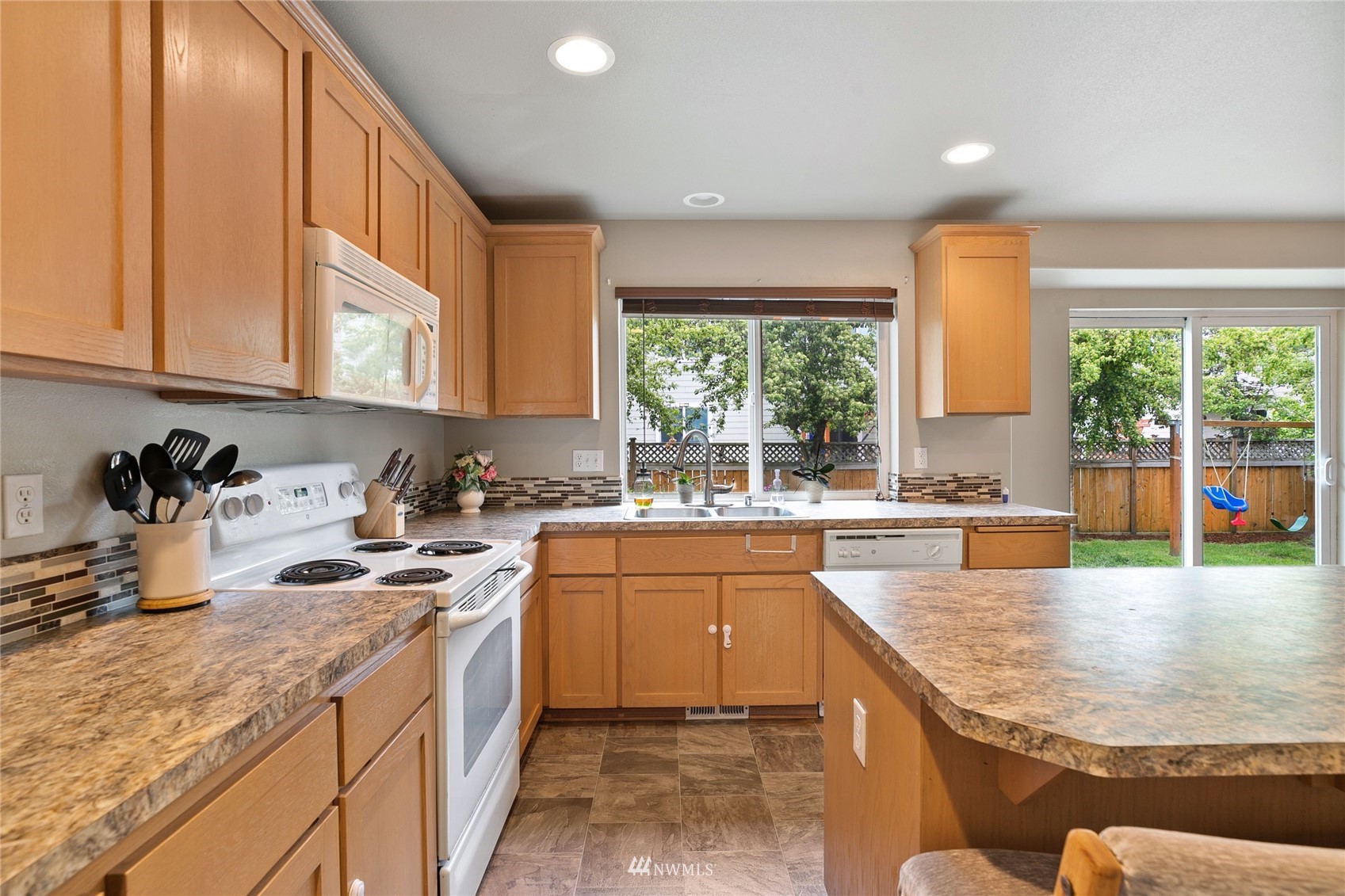 6924 Inlay Street Southeast Lacey, WA 98513 - Photo 5 of 20 a kitchen with a sink stove and cabinets