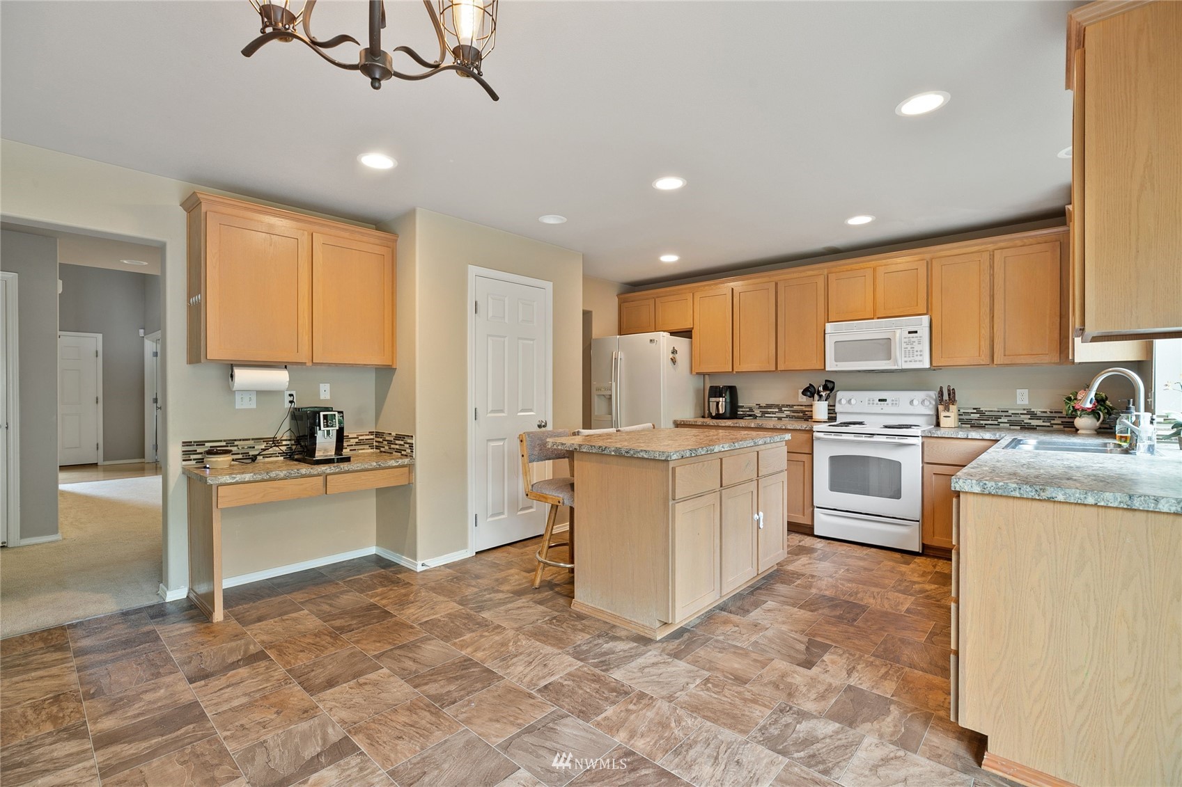 6924 Inlay Street Southeast Lacey, WA 98513 - Photo 6 of 20 a kitchen with granite countertop cabinets and stainless steel appliances