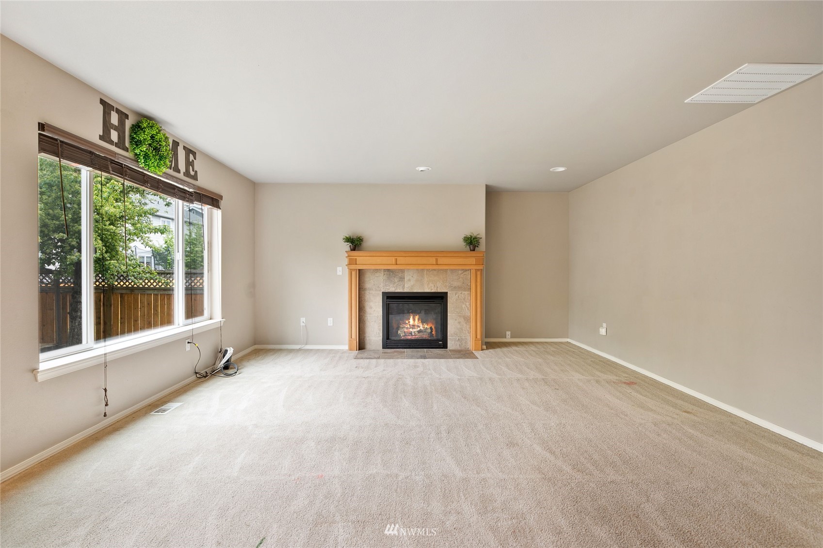 6924 Inlay Street Southeast Lacey, WA 98513 - Photo 7 of 20 a view of an empty room with a window and a fireplace