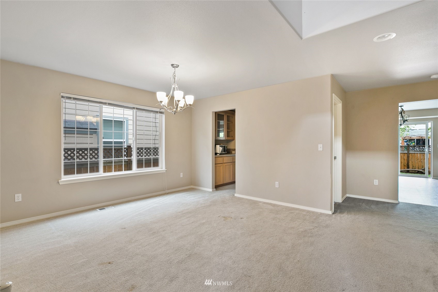 6924 Inlay Street Southeast Lacey, WA 98513 - Photo 8 of 20 an empty room with chandelier and windows