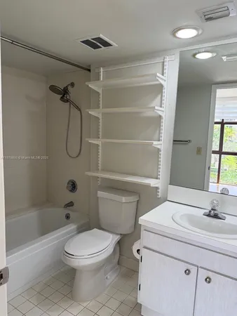 a utility room with wooden floor washer and dryer