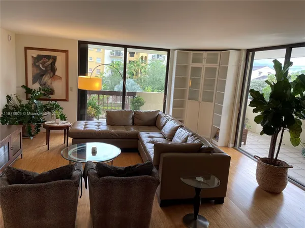 a view of a dining room with furniture and a potted plant