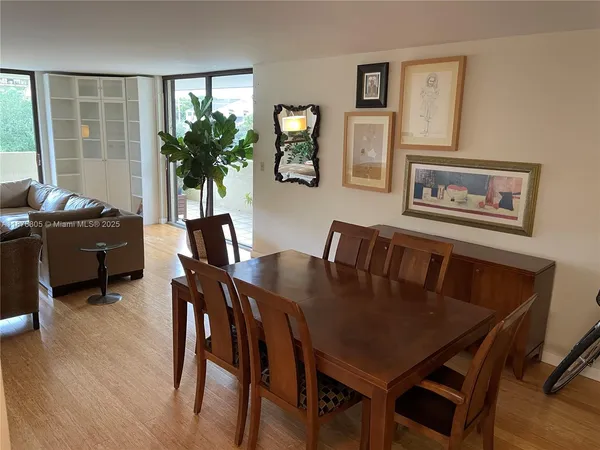 a living room with furniture ceiling fan and a wooden floor