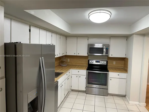 a bedroom with a bed and a lamp