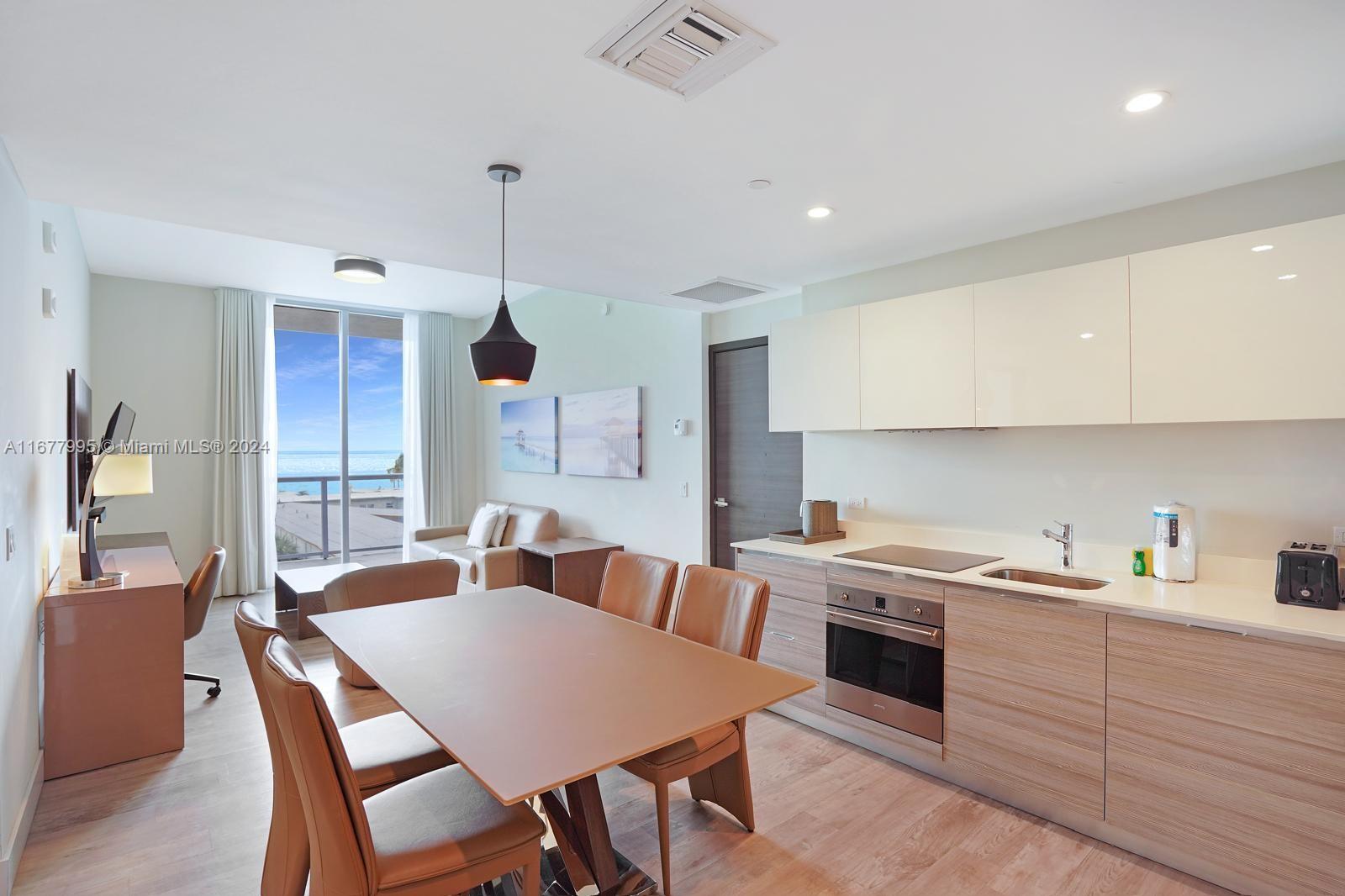 South Central Beach Hollywood, FL 33019 - Photo 14 of 23 a large kitchen with a table and chairs