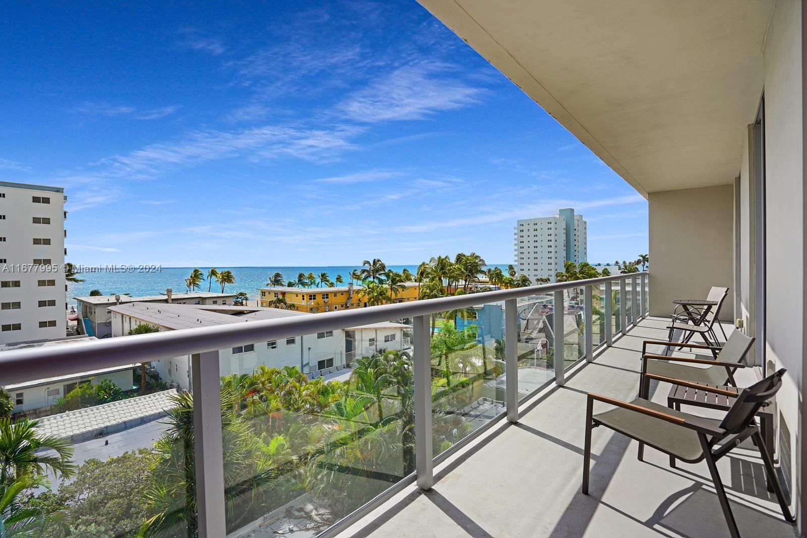 South Central Beach Hollywood, FL 33019 - Photo 3 of 23 a view of a balcony with wooden chairs and city view