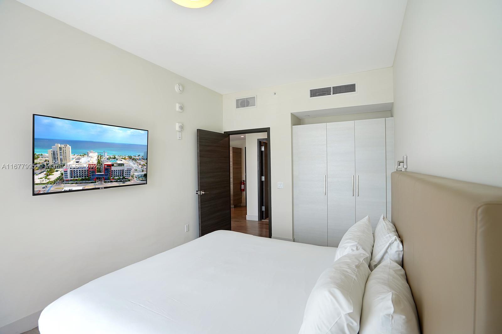 South Central Beach Hollywood, FL 33019 - Photo 4 of 23 a bedroom with a bed and a wall painting