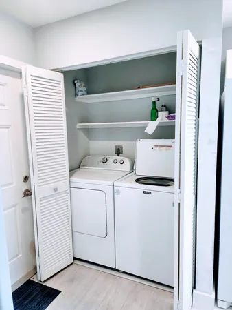 wooden floor in an empty room with a kitchen
