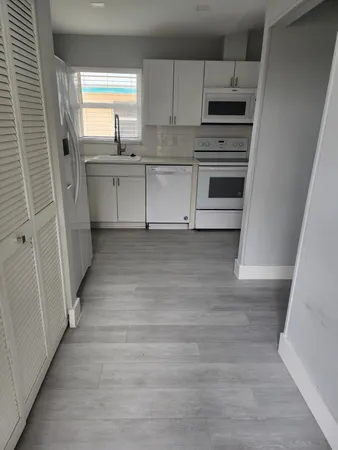 a view of a room with wooden floor