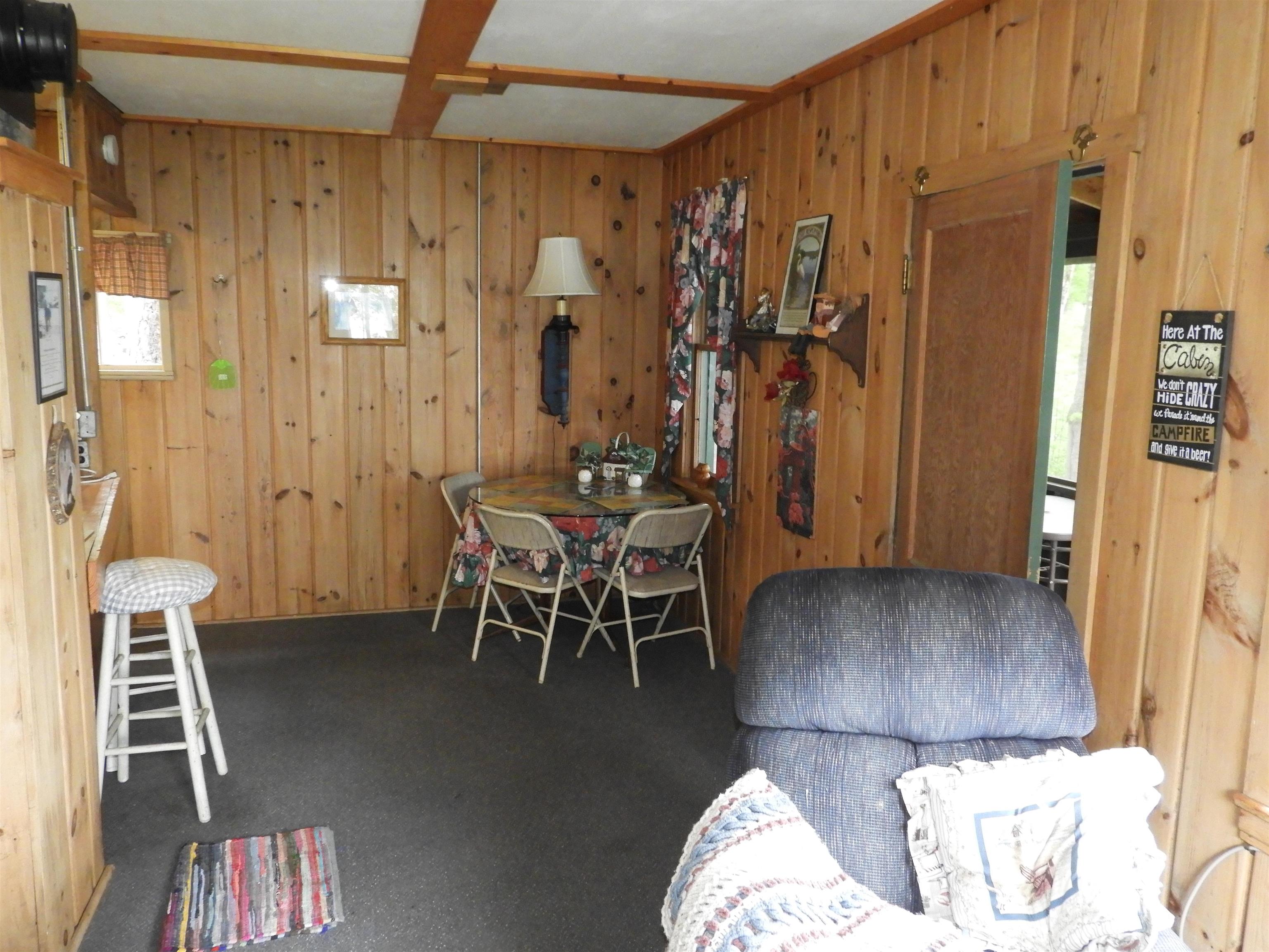 66490 Mieritz Road Iron River, WI 54847 - Photo 17 of 23 Carpeted dining space featuring wooden walls