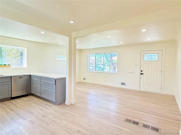 a view of a kitchen with wooden floor and electronic appliances