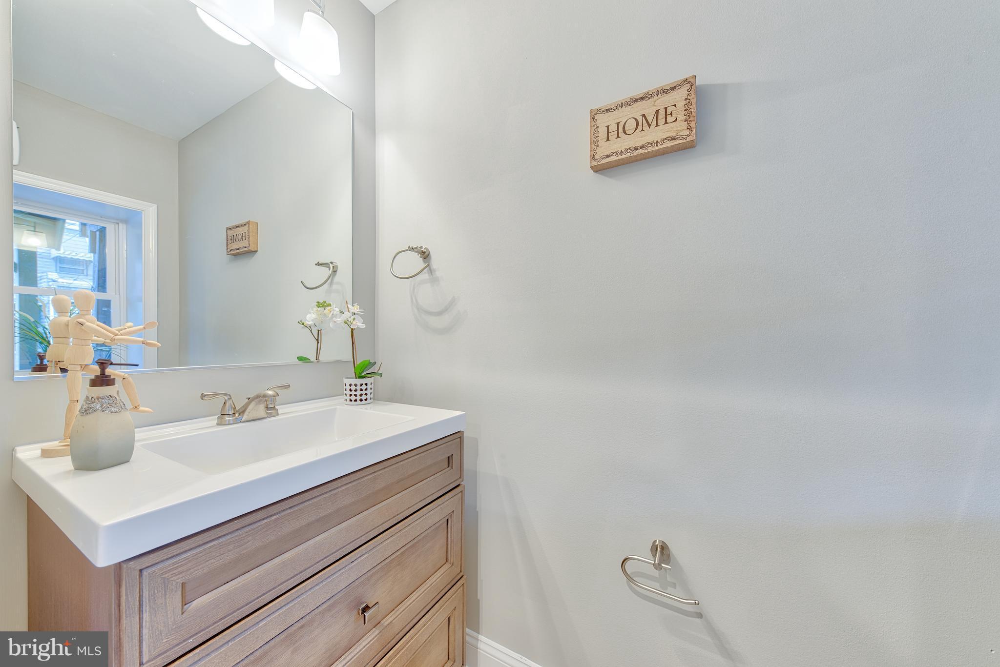 115 North Decker Avenue Baltimore, MD 21224 - Photo 12 of 30 a bathroom with a sink mirror and vanity