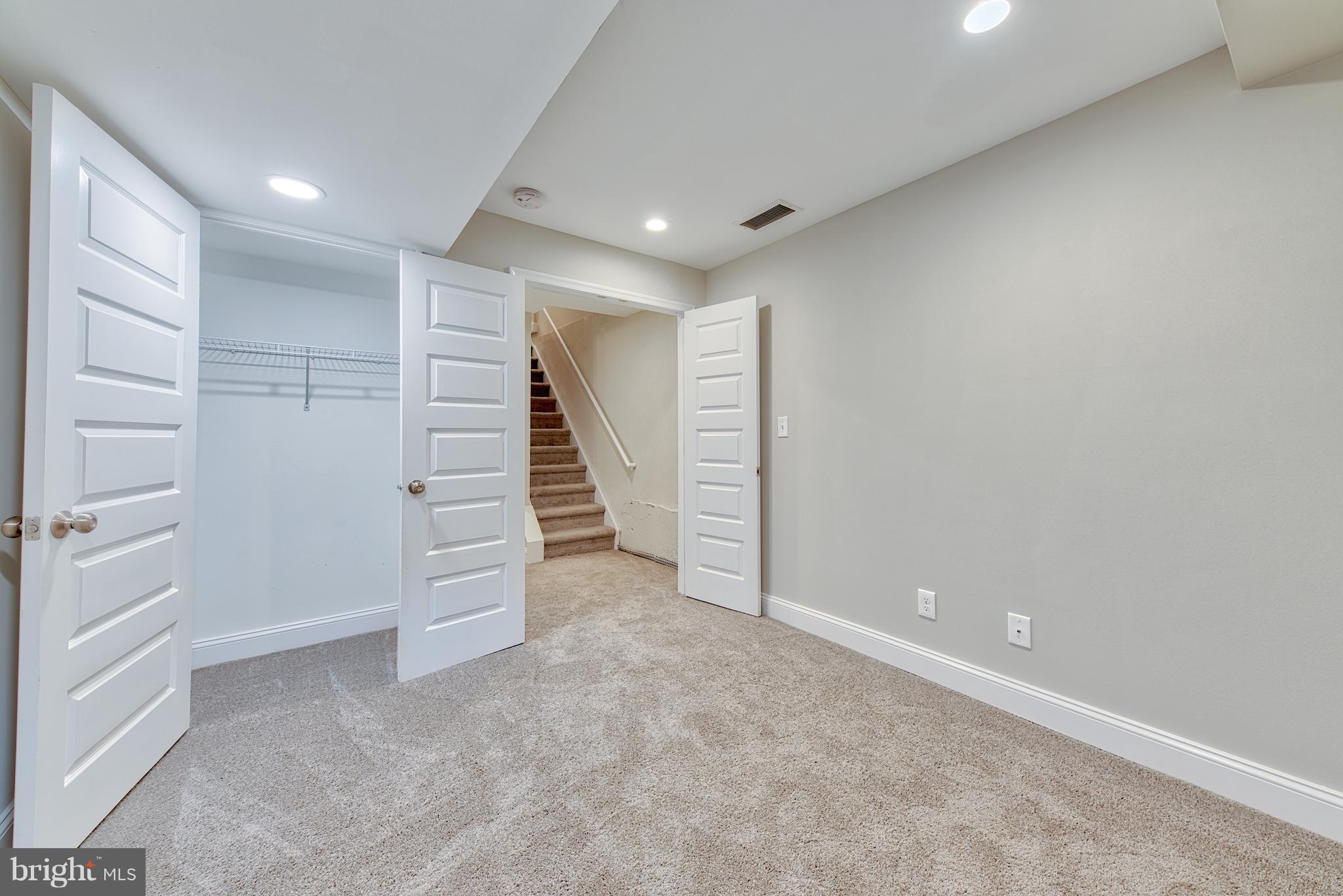 115 North Decker Avenue Baltimore, MD 21224 - Photo 15 of 30 an empty room with a hallway and stairs