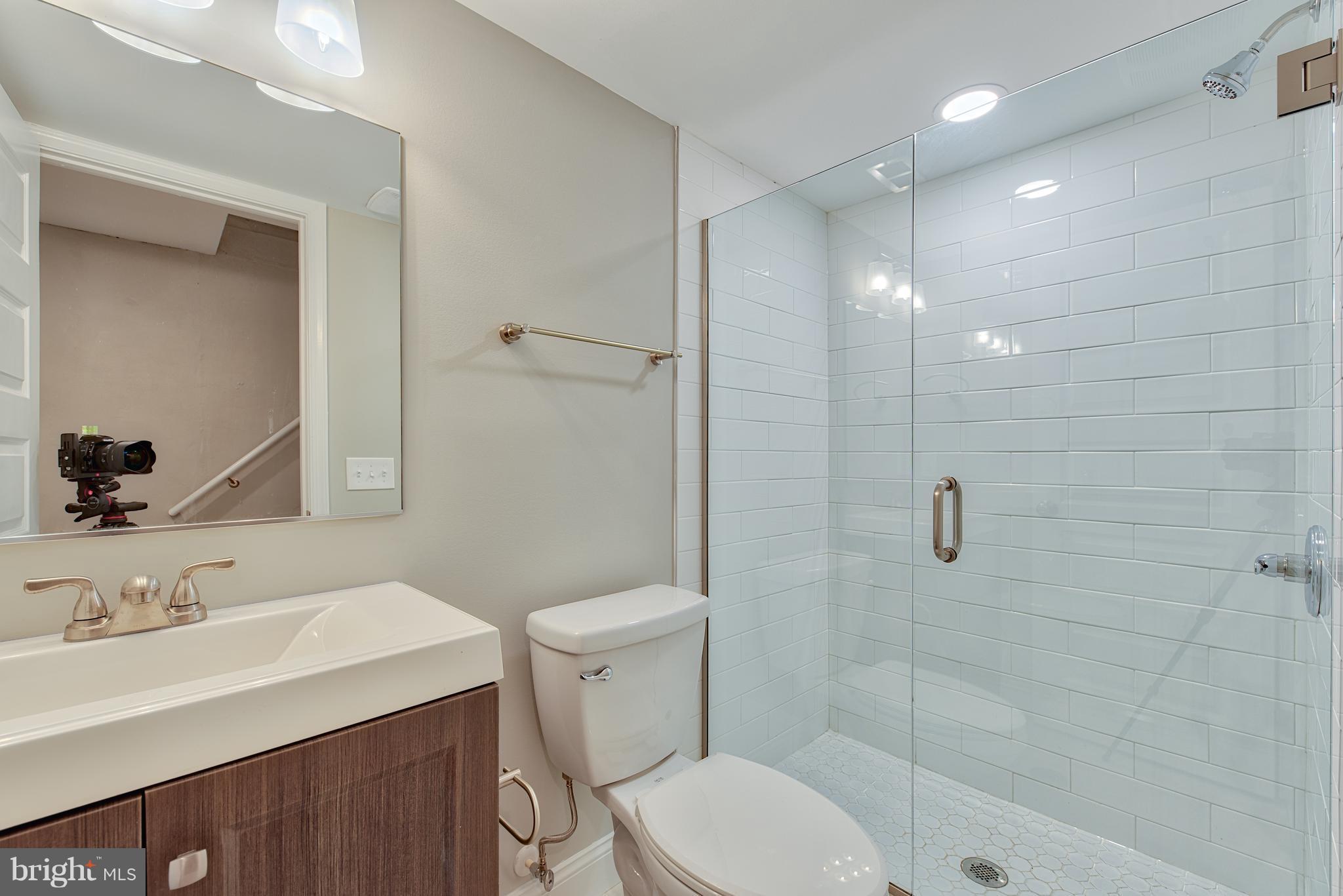 115 North Decker Avenue Baltimore, MD 21224 - Photo 17 of 30 a bathroom with a sink a toilet and shower