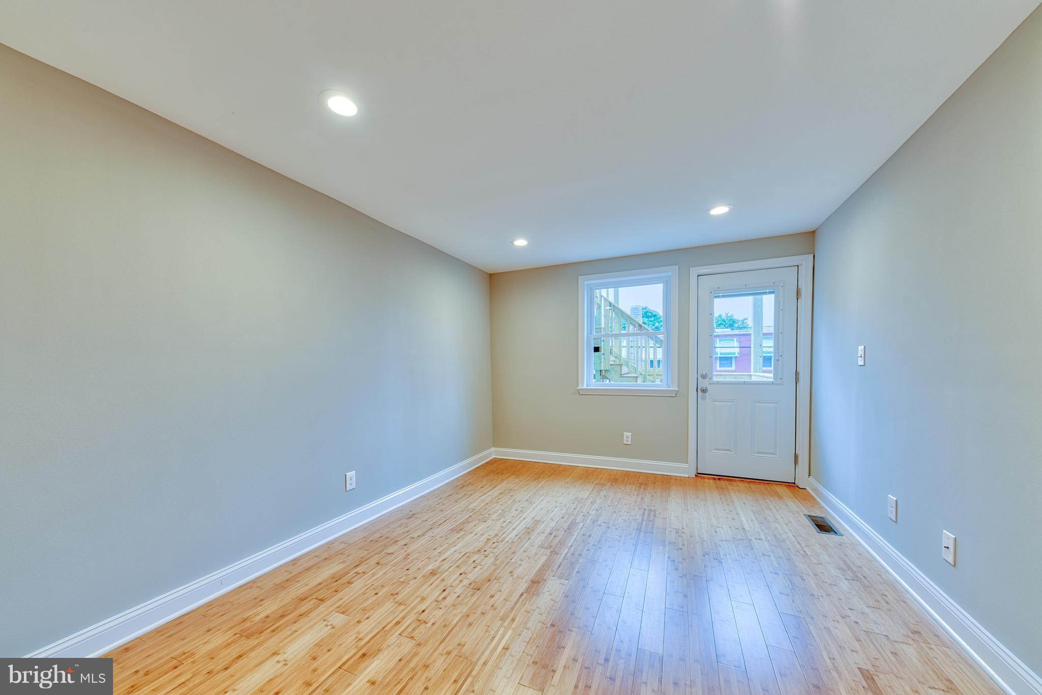 115 North Decker Avenue Baltimore, MD 21224 - Photo 19 of 30 a view of an empty room with wooden floor and a window