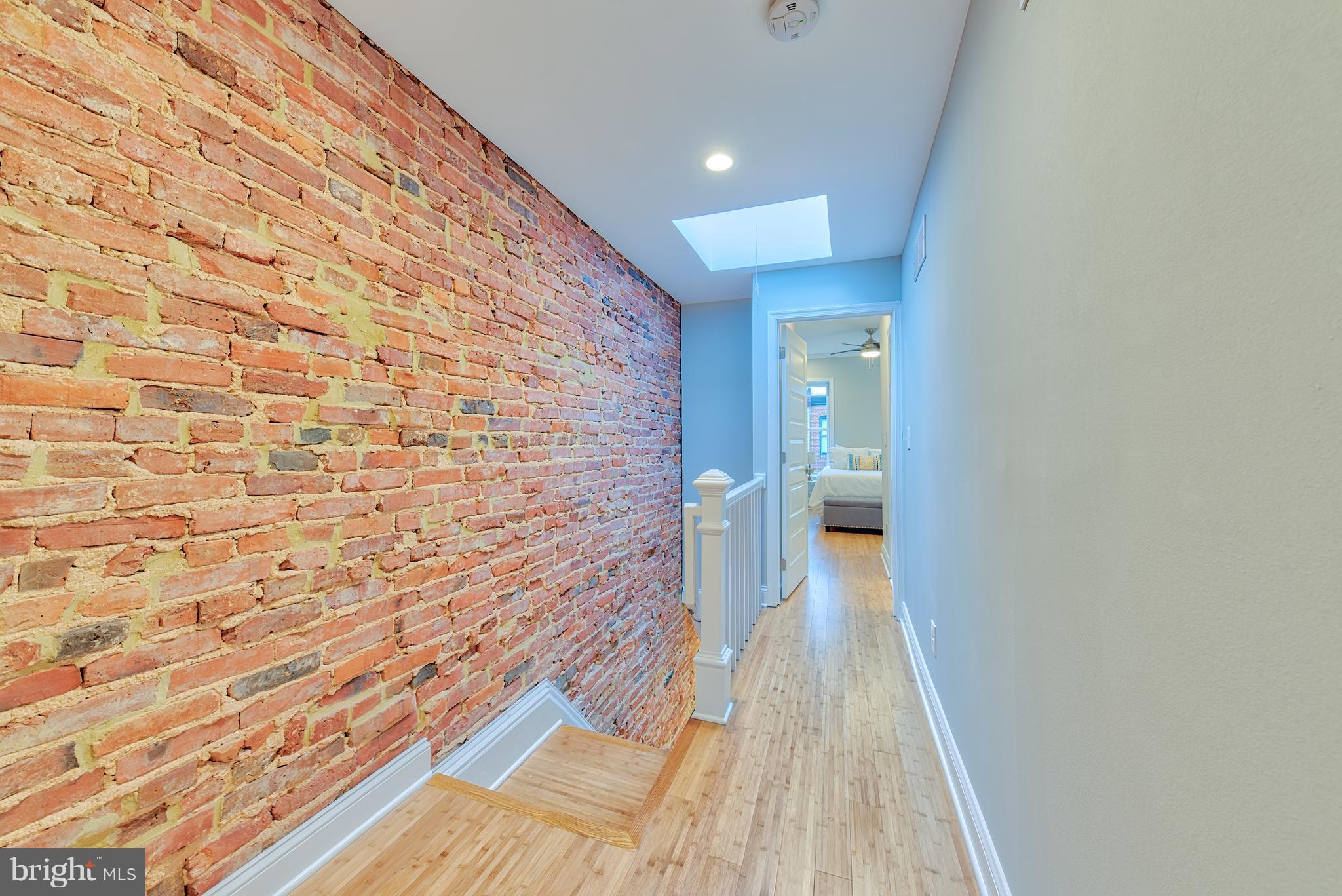 115 North Decker Avenue Baltimore, MD 21224 - Photo 22 of 30 a view of a hallway with wooden floor and a bathroom