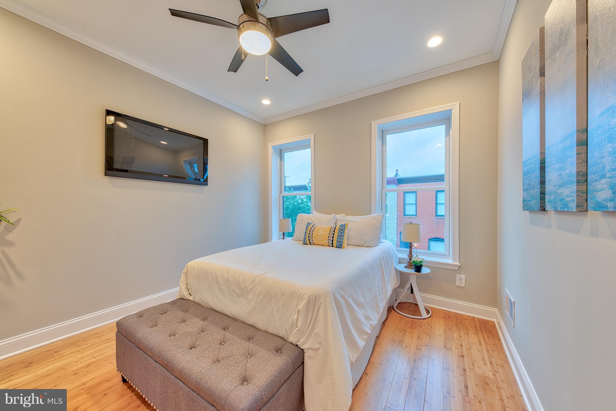 115 North Decker Avenue Baltimore, MD 21224 - Photo 23 of 30 a bedroom with a bed and a flat screen tv